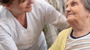 Old person and professional caregiver