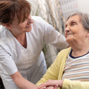 Old person and professional caregiver